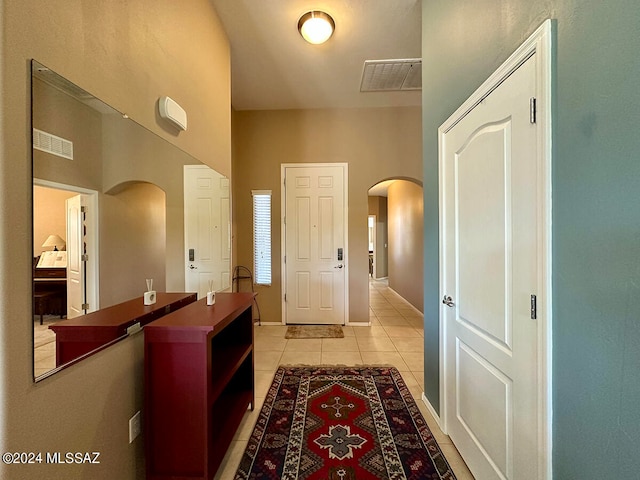 hall with light tile patterned floors