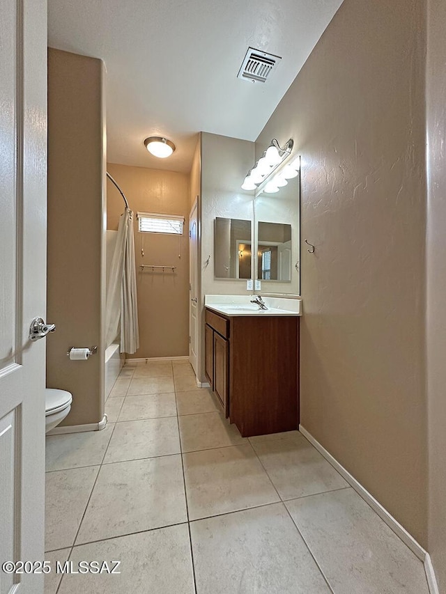 full bathroom featuring visible vents, toilet, vanity, tile patterned flooring, and baseboards