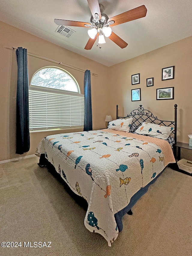 carpeted bedroom with ceiling fan