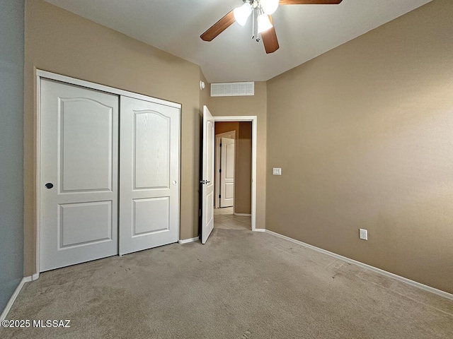 unfurnished bedroom featuring light carpet, baseboards, visible vents, and a closet