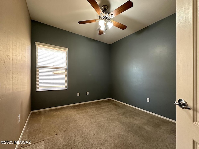 empty room with a ceiling fan, carpet flooring, and baseboards