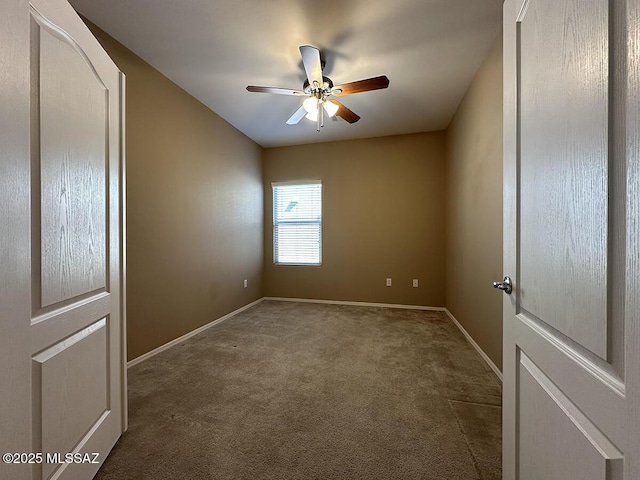 empty room with carpet floors, ceiling fan, and baseboards