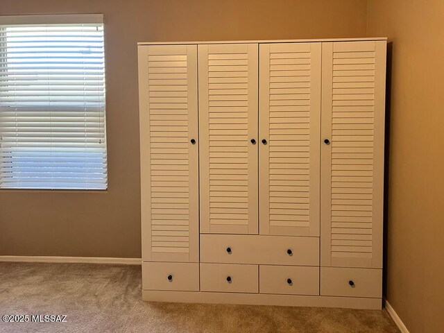 miscellaneous room featuring ceiling fan and light colored carpet