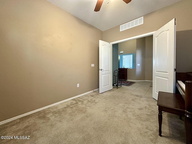 unfurnished bedroom with light carpet, ceiling fan, visible vents, and baseboards