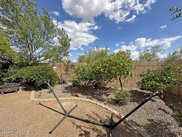 view of yard featuring an outdoor fire pit and a fenced backyard