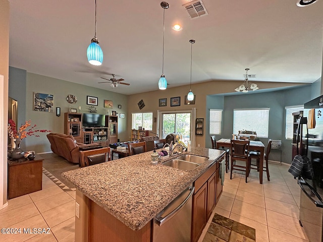 kitchen featuring dishwasher, ceiling fan with notable chandelier, sink, and an island with sink