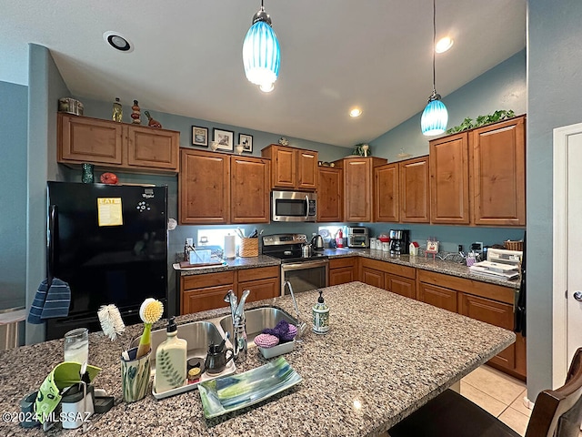 kitchen featuring stainless steel appliances, decorative light fixtures, light tile patterned floors, light stone countertops, and vaulted ceiling