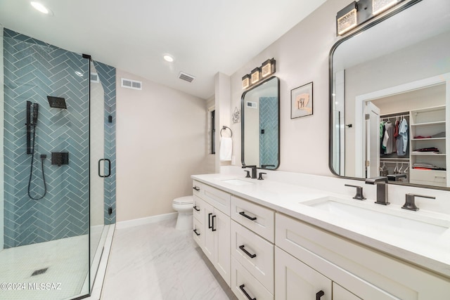 bathroom with an enclosed shower, vanity, and toilet