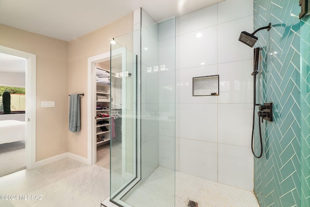 bathroom with a shower with door