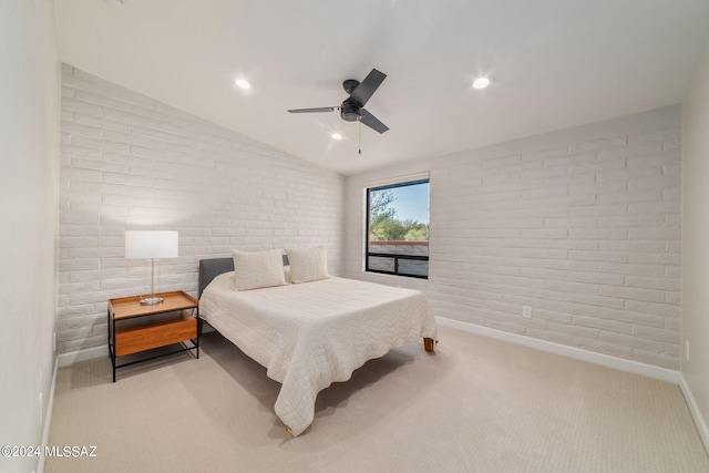 bedroom featuring vaulted ceiling, ceiling fan, brick wall, and light carpet