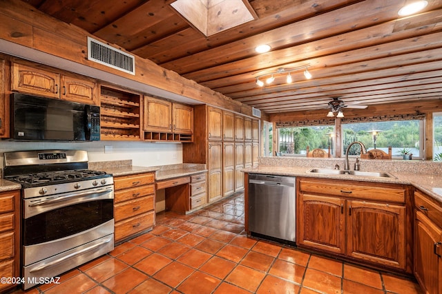 kitchen featuring a skylight, sink, ceiling fan, wooden ceiling, and appliances with stainless steel finishes