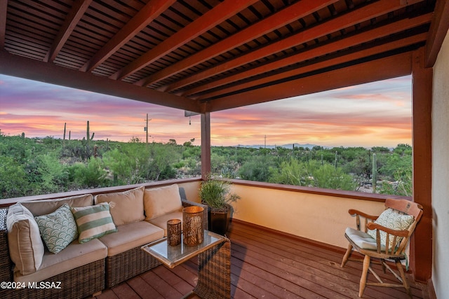 deck at dusk featuring an outdoor hangout area