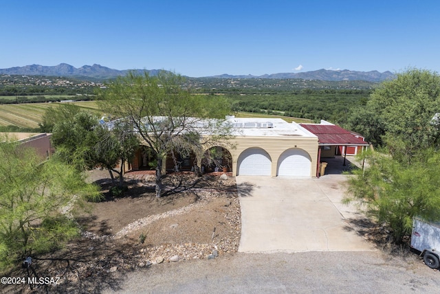 view of front facade featuring a garage and a mountain view