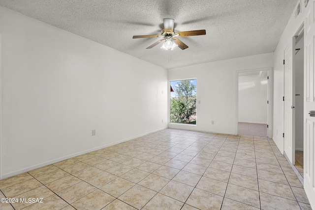 unfurnished room featuring a textured ceiling, light tile patterned floors, and ceiling fan