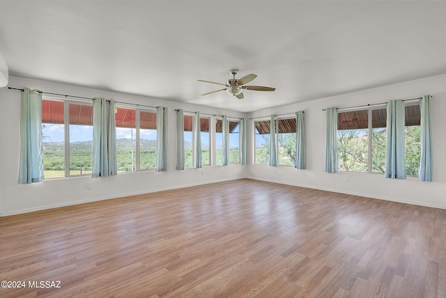 unfurnished sunroom with a wealth of natural light and ceiling fan