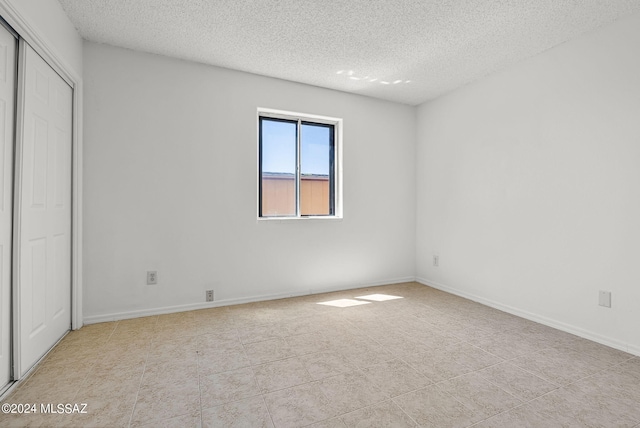 unfurnished bedroom with a textured ceiling