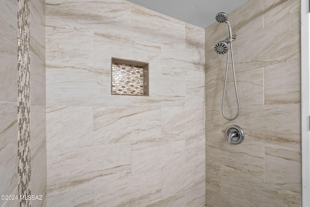 bathroom with tiled shower