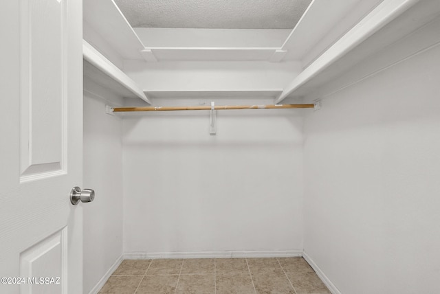 spacious closet with light tile patterned flooring