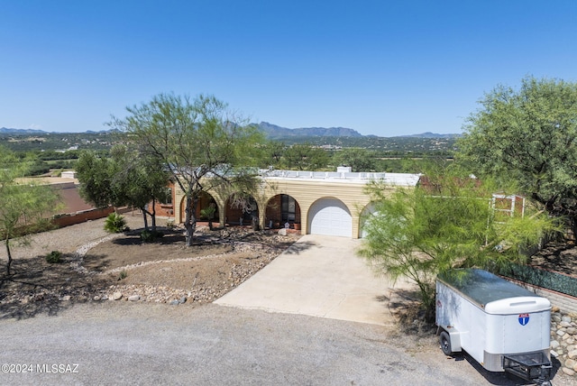 view of front of house featuring a garage and a mountain view