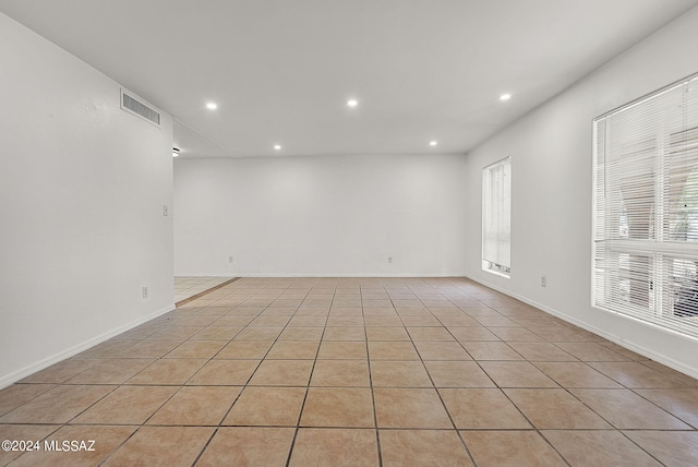 tiled empty room featuring a healthy amount of sunlight