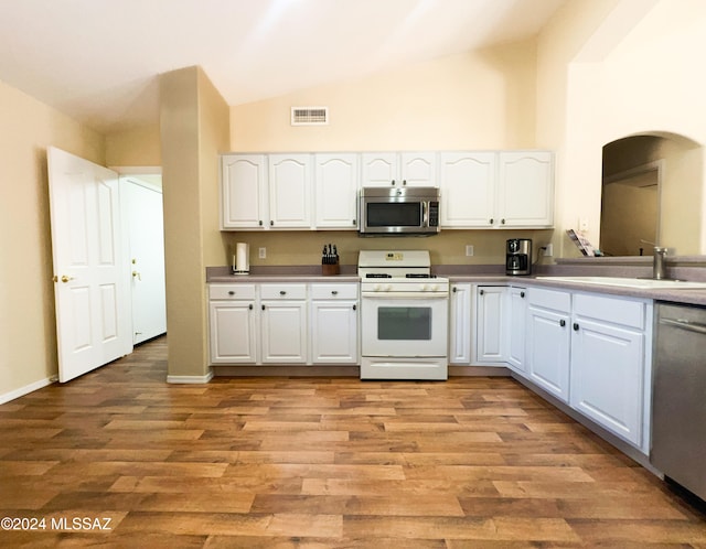 kitchen featuring appliances with stainless steel finishes, light hardwood / wood-style floors, and white cabinetry