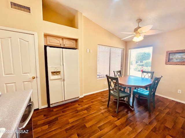 dining space featuring ceiling fan, dark wood-type flooring, and vaulted ceiling