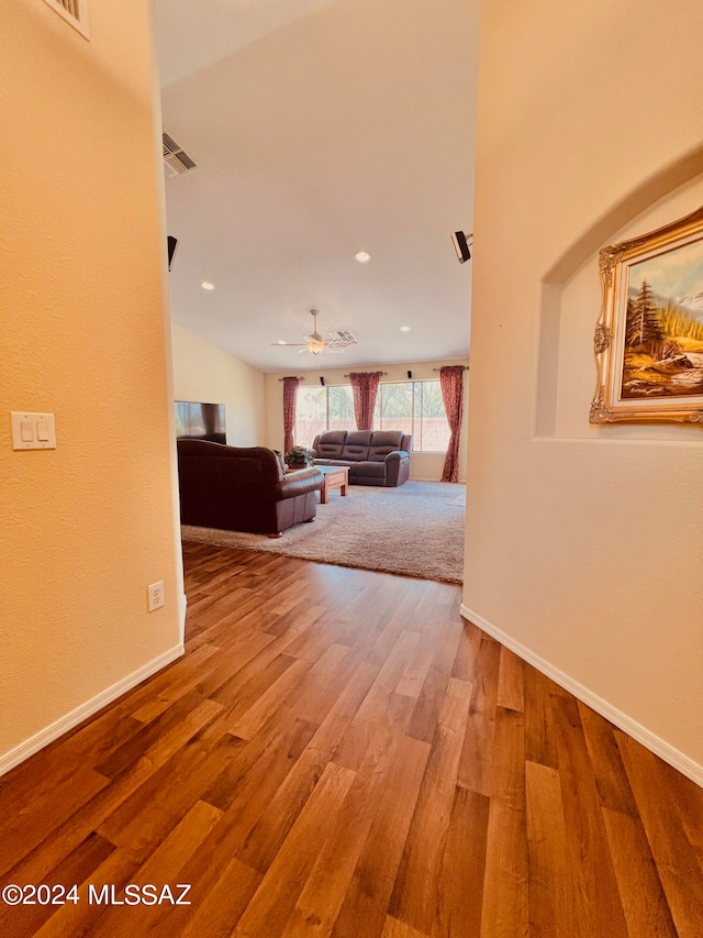 hallway with hardwood / wood-style flooring