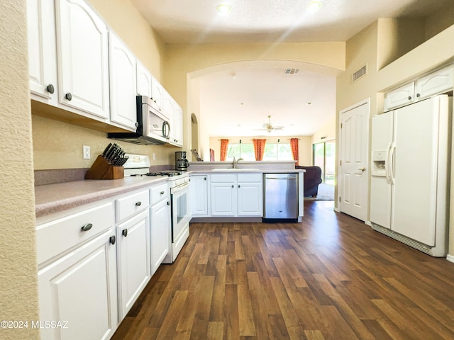 kitchen featuring sink, stainless steel appliances, kitchen peninsula, dark hardwood / wood-style floors, and white cabinetry