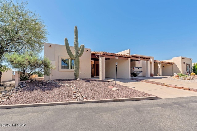 pueblo-style house with a patio