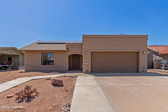 view of front of house with a garage and solar panels