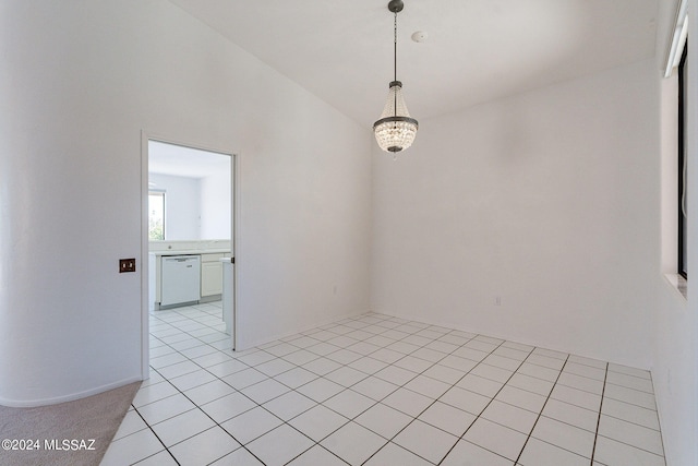 unfurnished room with a notable chandelier and light tile patterned flooring