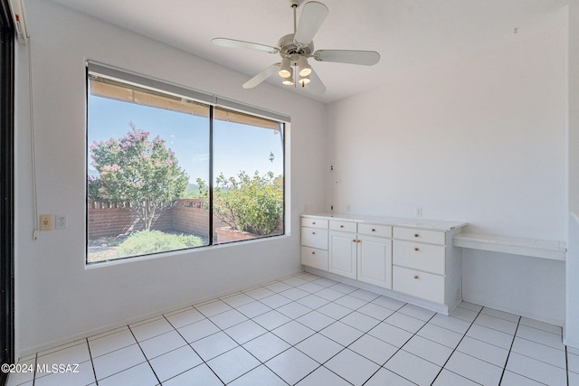 interior space featuring light tile patterned flooring and ceiling fan