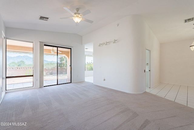 carpeted spare room with vaulted ceiling and ceiling fan