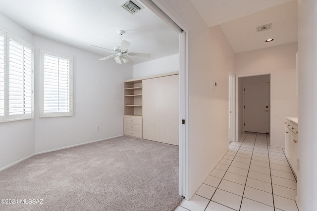 hallway featuring light colored carpet