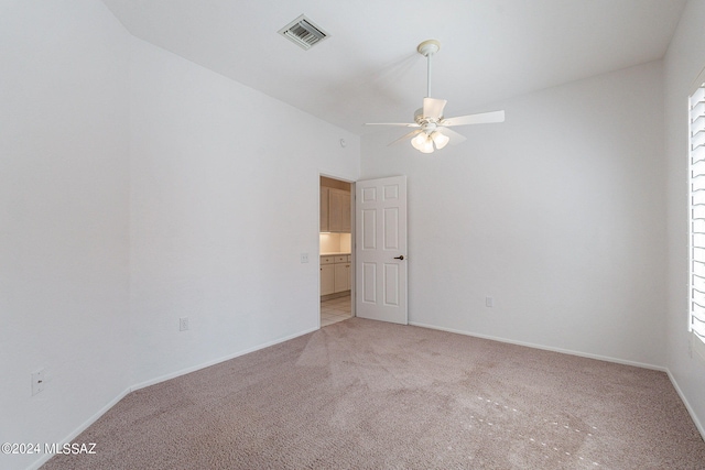 unfurnished room with ceiling fan and light colored carpet