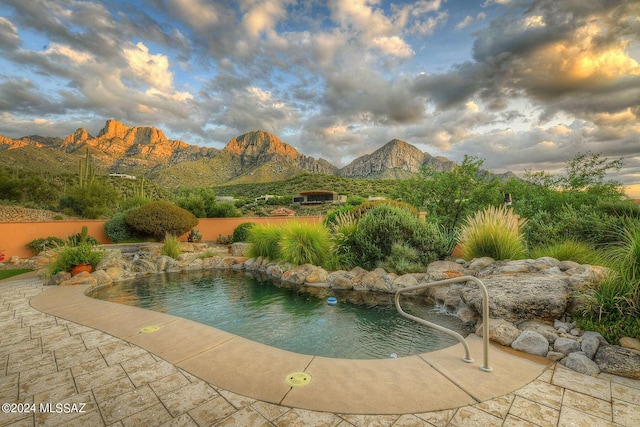 view of pool with a fenced in pool and a mountain view