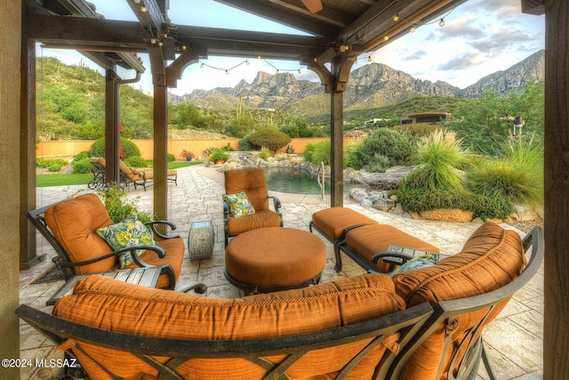 view of patio with a mountain view, a fenced backyard, and a pool
