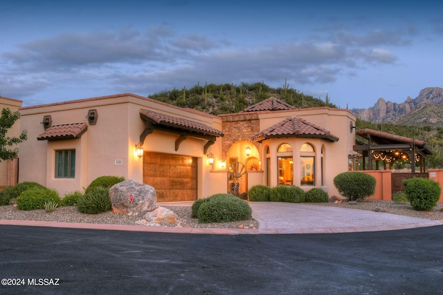 mediterranean / spanish home featuring a garage and a mountain view