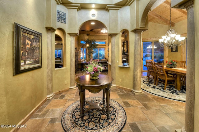 hall featuring high vaulted ceiling, wooden ceiling, a notable chandelier, beam ceiling, and decorative columns