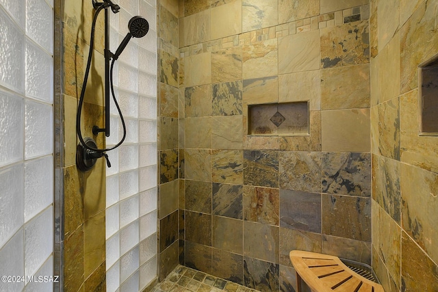 bathroom with a tile shower