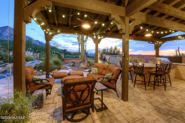 view of patio featuring outdoor dry bar, grilling area, and an outdoor living space