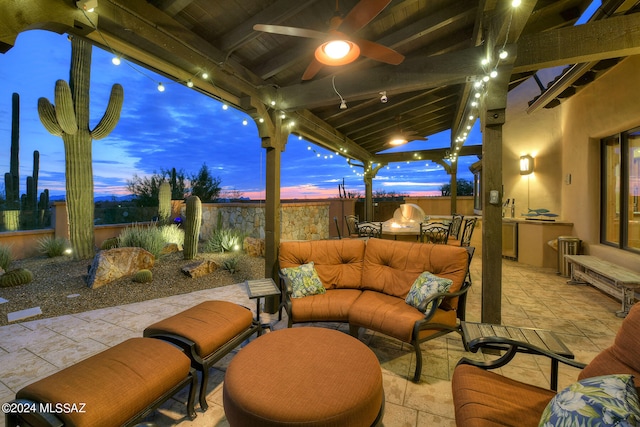 patio terrace at dusk featuring ceiling fan and outdoor lounge area