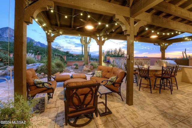 view of patio featuring an outdoor living space, a fenced backyard, and outdoor dry bar