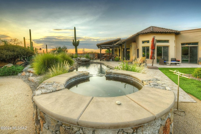 view of swimming pool featuring a fenced in pool, fence, a patio, and an in ground hot tub