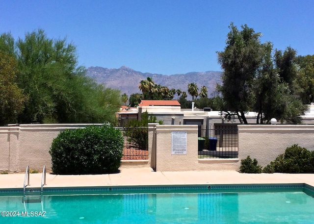 view of swimming pool with a mountain view