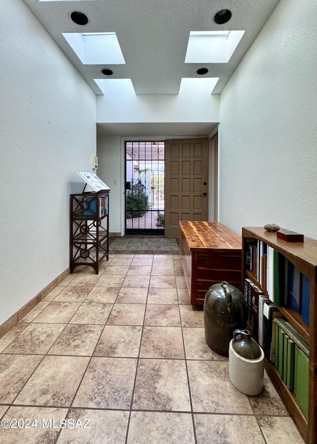 interior space with a skylight and a textured ceiling