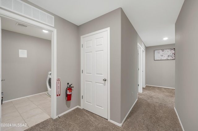 6524 S Diablo Dr, Tucson, AZ 85757 - hallway featuring baseboards, washer / clothes dryer, visible vents, and light colored carpet