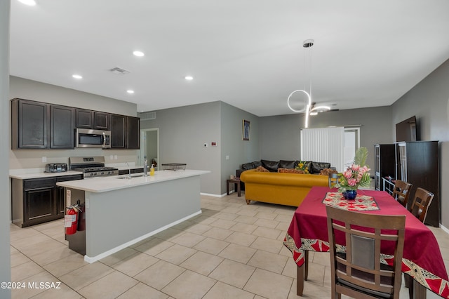 6524 S Diablo Dr, Tucson, AZ 85757 - kitchen featuring stainless steel appliances, light countertops, a sink, and light tile patterned flooring