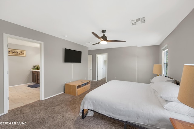 6524 S Diablo Dr, Tucson, AZ 85757 - carpeted bedroom featuring visible vents, a ceiling fan, connected bathroom, baseboards, and tile patterned floors