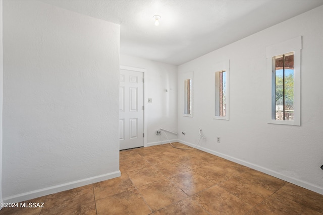 spare room featuring baseboards